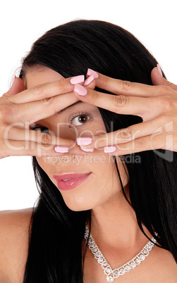 Woman holding hands over face looking trough