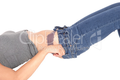 Woman lying on floor pulling jeans up