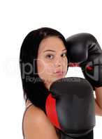 Close up of woman with black boxing cloves