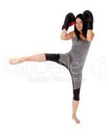 Woman in kick boxing action fighting