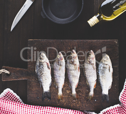 Purified river fish from the scales on brown wooden board