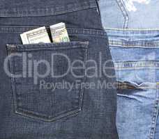 banknotes of the American dollar in the back pocket of blue jean