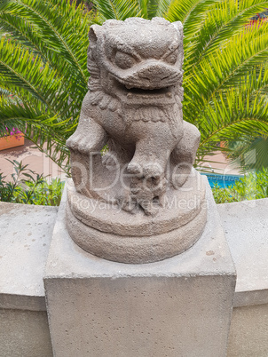 Ancient Chinese Emperor lion statue on a stone pedestal