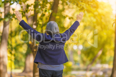 Happy woman with arms outstretched