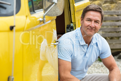 Attractive, successful and happy middle aged man male wearing a blue polo shirt