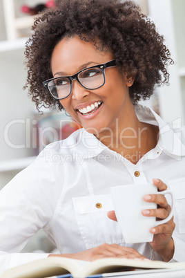 Mixed Race African American Girl Drinking Coffee Reading Book