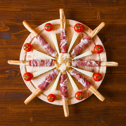 Chopping board with ham cheese and cherry tomatoes