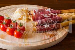 Ham rolled in breadsticks cheese and cherry tomatoes