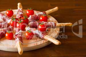 Italian chopping board with ham cheese and cherry tomatoes