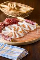 Salami chopping board with breadsticks and napkin