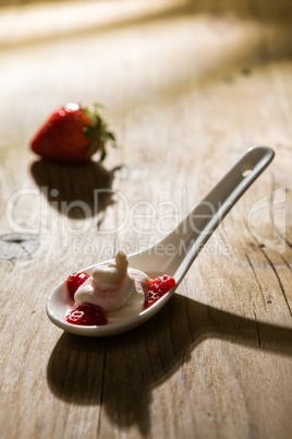 Mascarpone cream and strawberries in backlight