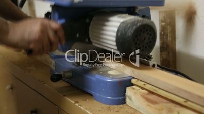 Carpenter Cutting Wood with Concentration