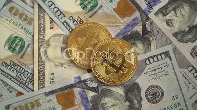 Gold Bit Coin BTC coins rotating on bills of American dollars
