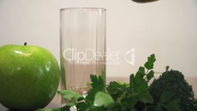 Pouring Green Juice Into Glass