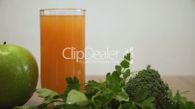 Orange juice, apple and green foods for healthy breakfast.