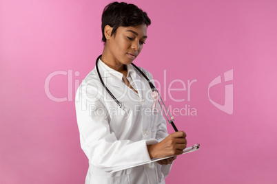 Writing nurse wearing breast cancer awareness pink ribbon