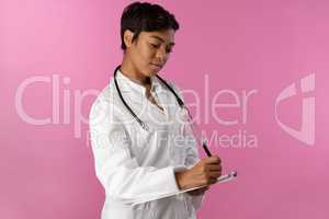 Writing nurse wearing breast cancer awareness pink ribbon