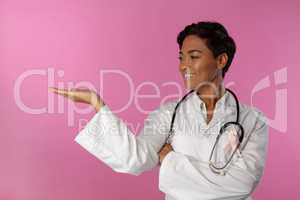 Nurse wearing breast cancer awareness pink ribbon shows a copy space