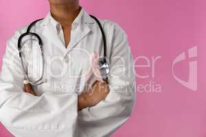 arms crossed nurse wearing breast cancer pink ribbon