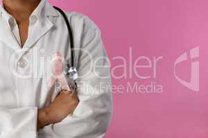 arms crossed nurse wearing breast cancer awareness pink ribbon