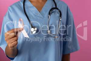 Nurse holding breast cancer awareness pink ribbon