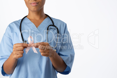 Nurse holding pink ribbon with both hands