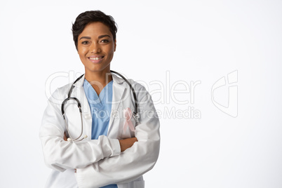 female doctor wearing breast cancer awareness pink ribbon with crossed arms