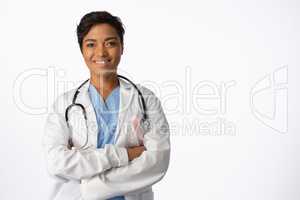 female doctor wearing breast cancer awareness pink ribbon with crossed arms