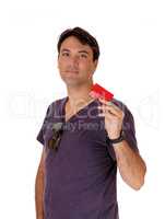 young man holding up his red credit card