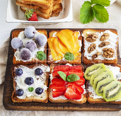 French toasts with soft cheese, strawberries, kiwi, walnuts, che