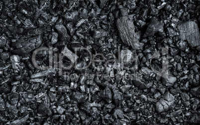 texture of black burnt coal with wooden logs