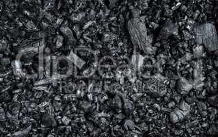 texture of black burnt coal with wooden logs