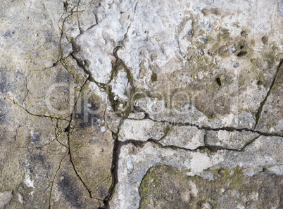 fragment of gray cement wall with cracks, full frame