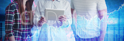 Composite image of businessman explaining to colleagues over tablet