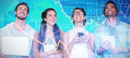 Composite image of smiling business people holding technology while looking up