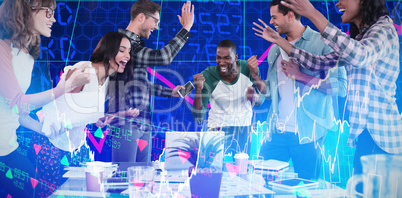 Composite image of cheerful business people standing at table