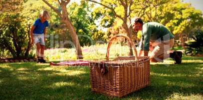 Father and son spreading the picnic blanket