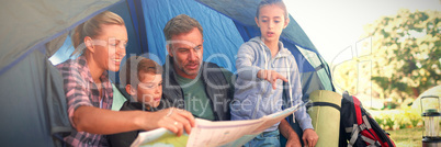 Family reading the map in tent