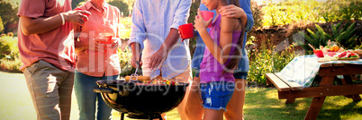 Family talking while preparing barbecue in the park Family talking while preparing barbecue in the park