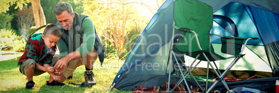 Father and son setting up a tent