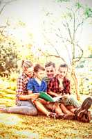 Family reading a book in the park