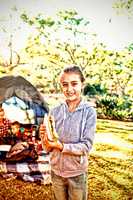 Smiling girl holding a sandwich at campsite