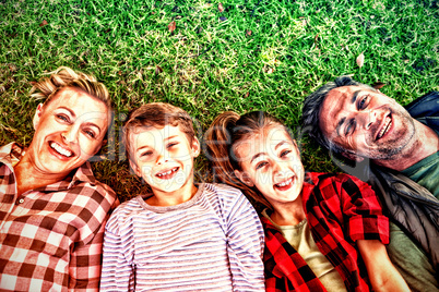 Happy family lying on the grass in park