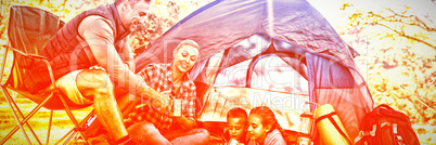 Family having snacks and coffee outside the tent Family having snacks and coffee outside the tent