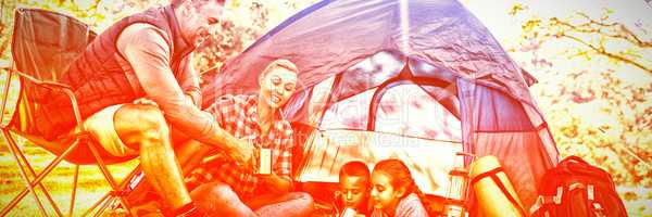 Family having snacks and coffee outside the tent