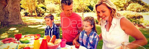 Happy family having meal in park