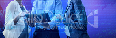 Composite image of businessman explaining to businesswomen over laptop