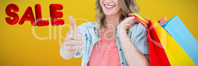 Composite image of woman holding some shopping bags