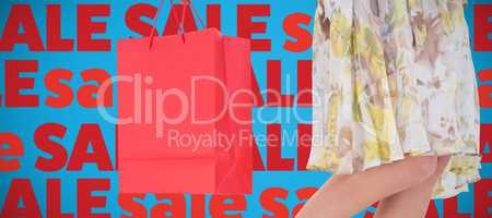 Composite image of elegant woman holding shopping bag
