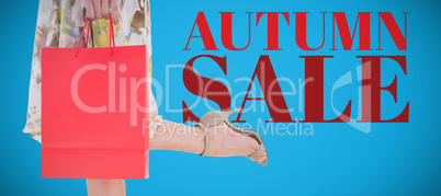 Composite image of elegant woman holding shopping bag